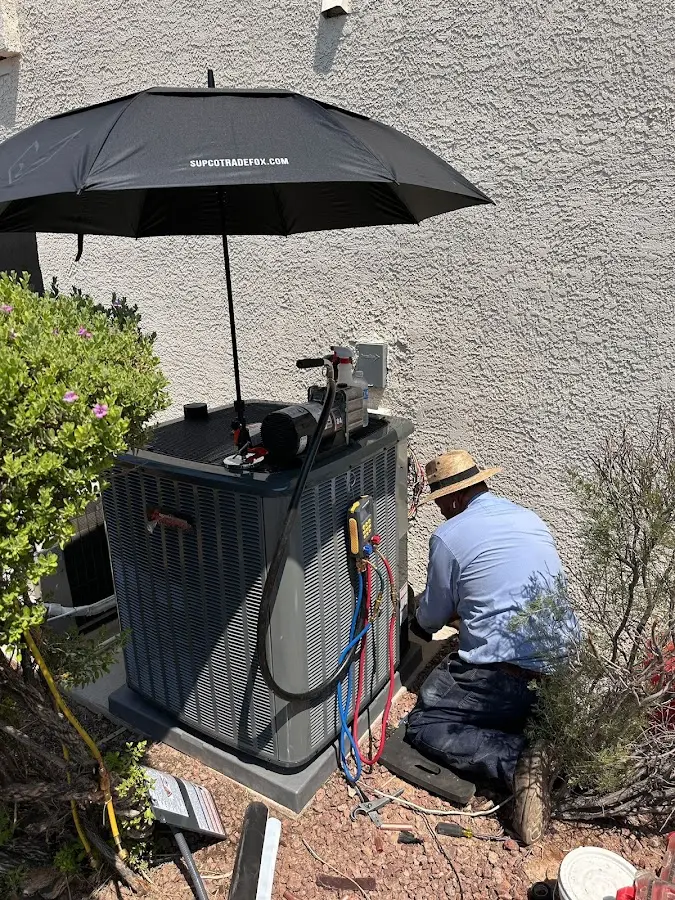 HVAC technician performing outdoor AC maintenance in Lancaster